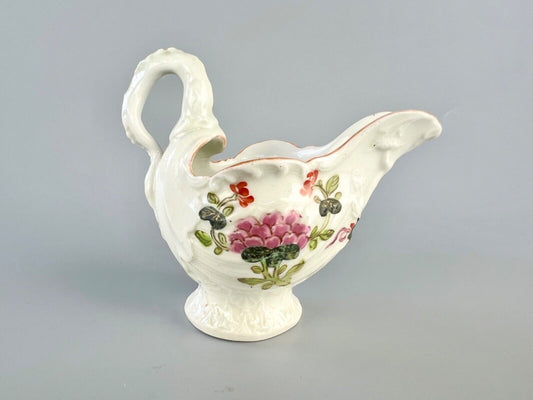 A c.1765 Worcester lamprey-handled dolphin ewer cream jug painted with flowers.