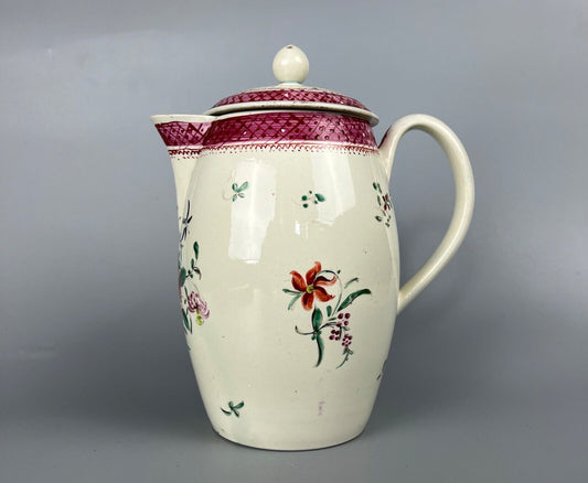 A late 18thc pearlware covered jug. Polychrome floral decoration.