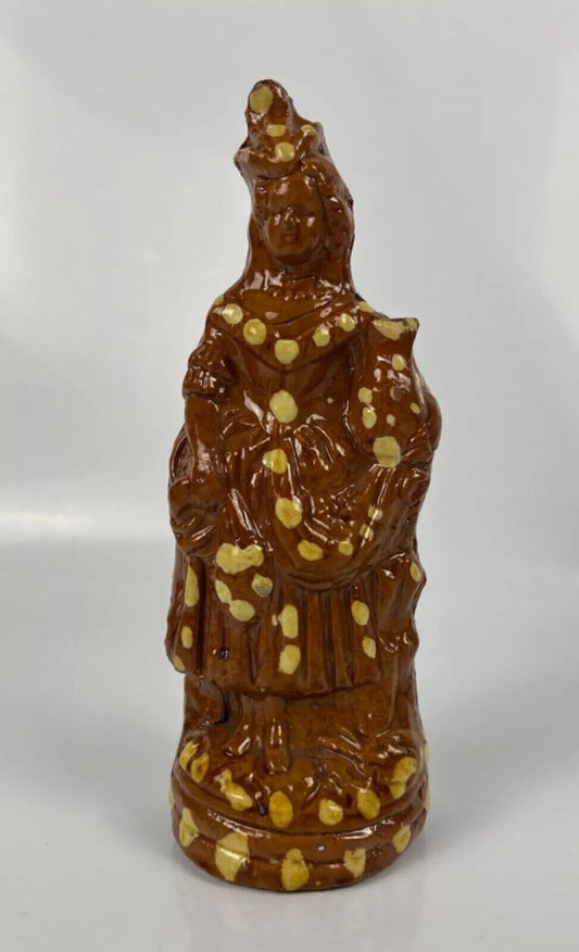 A cream dot decorated slipware figure of a woman on a treacle ground c1835