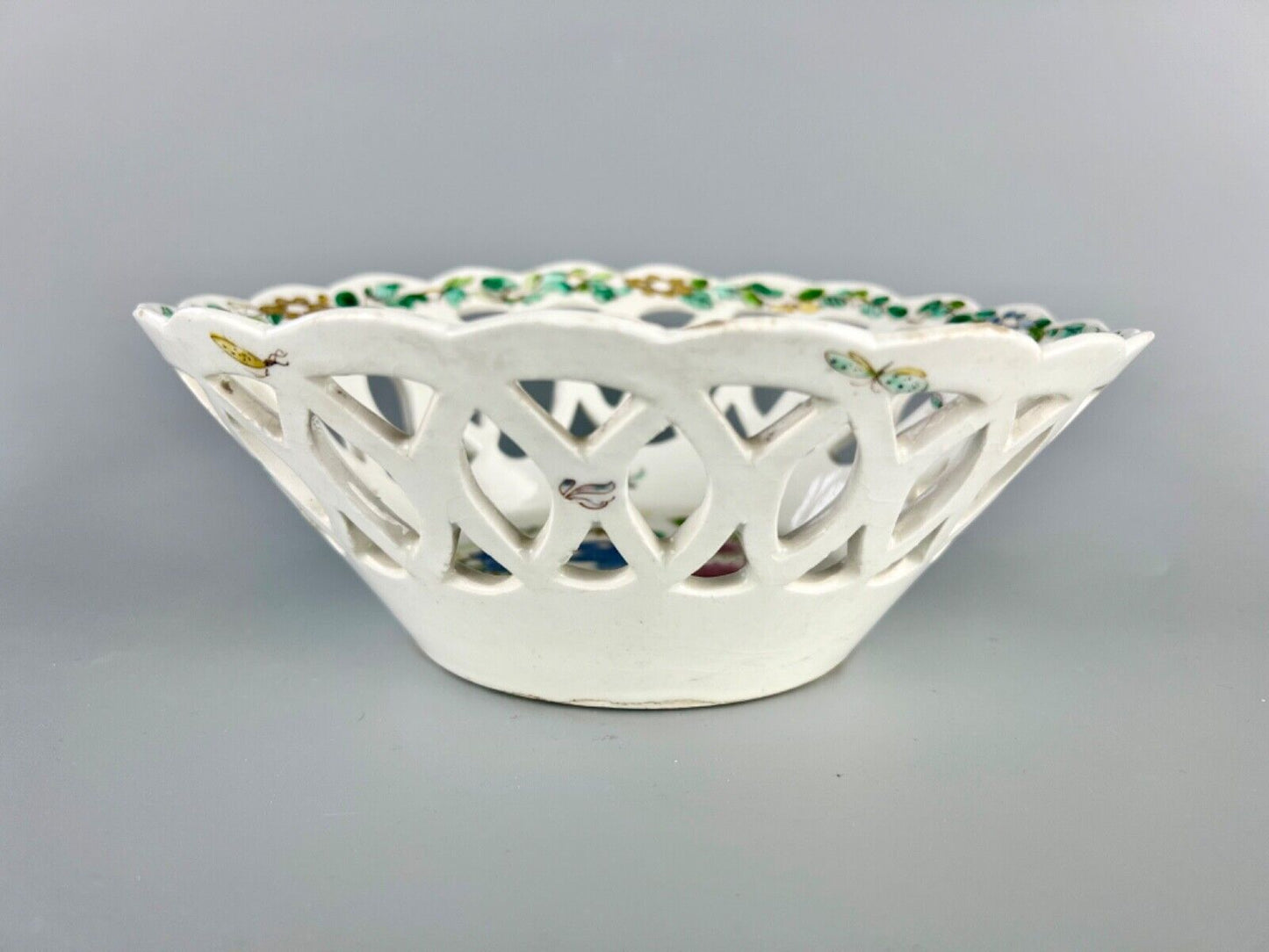 A fine and early Bow porcelain famille rose reticulated basket c.1752