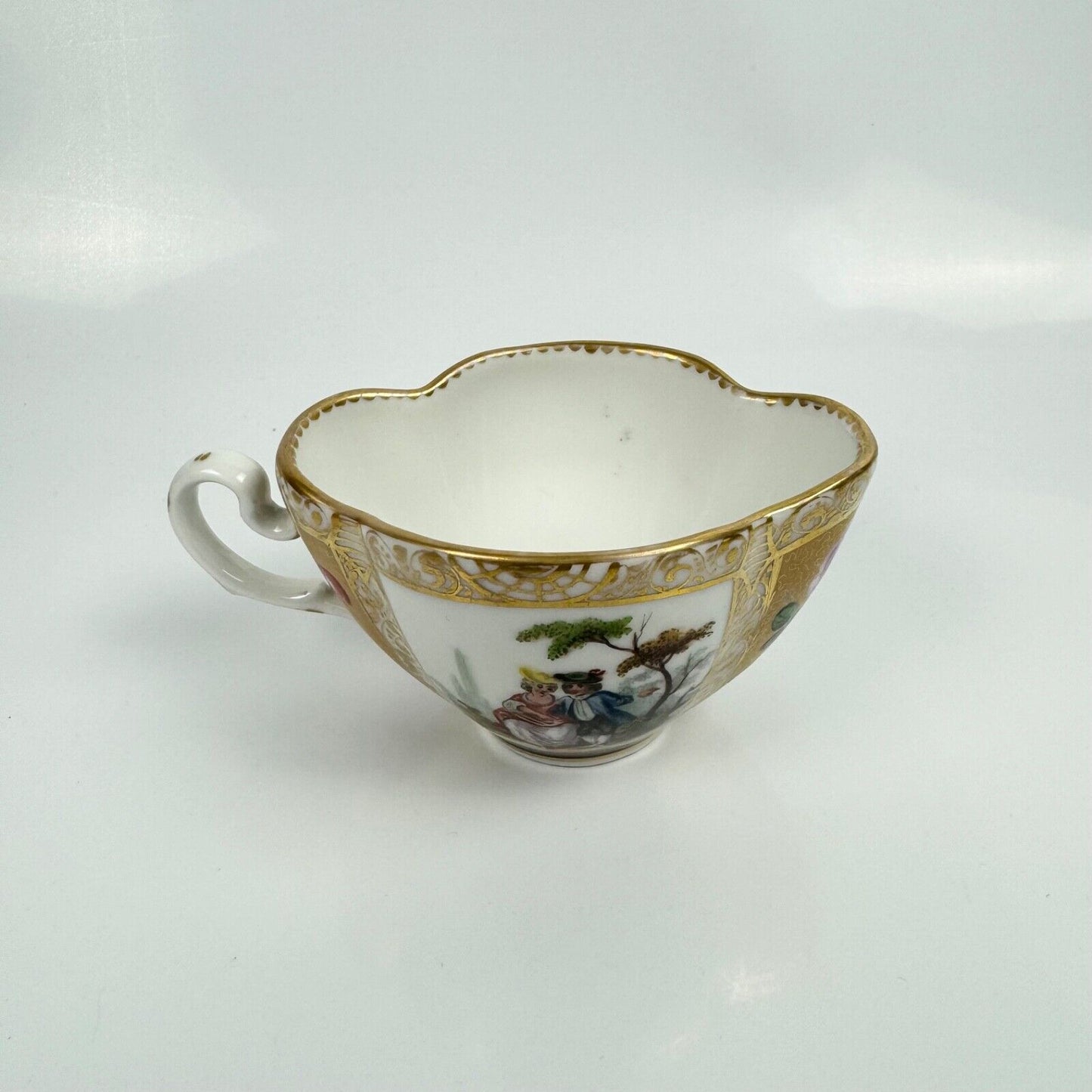 Dresden quatrefoil teacup & saucer painted with romantic scenes. 'AR' mark c1880