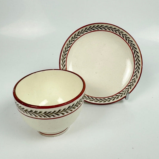 A fine creamware teabowl and saucer with painted foliate decoration. c.1790