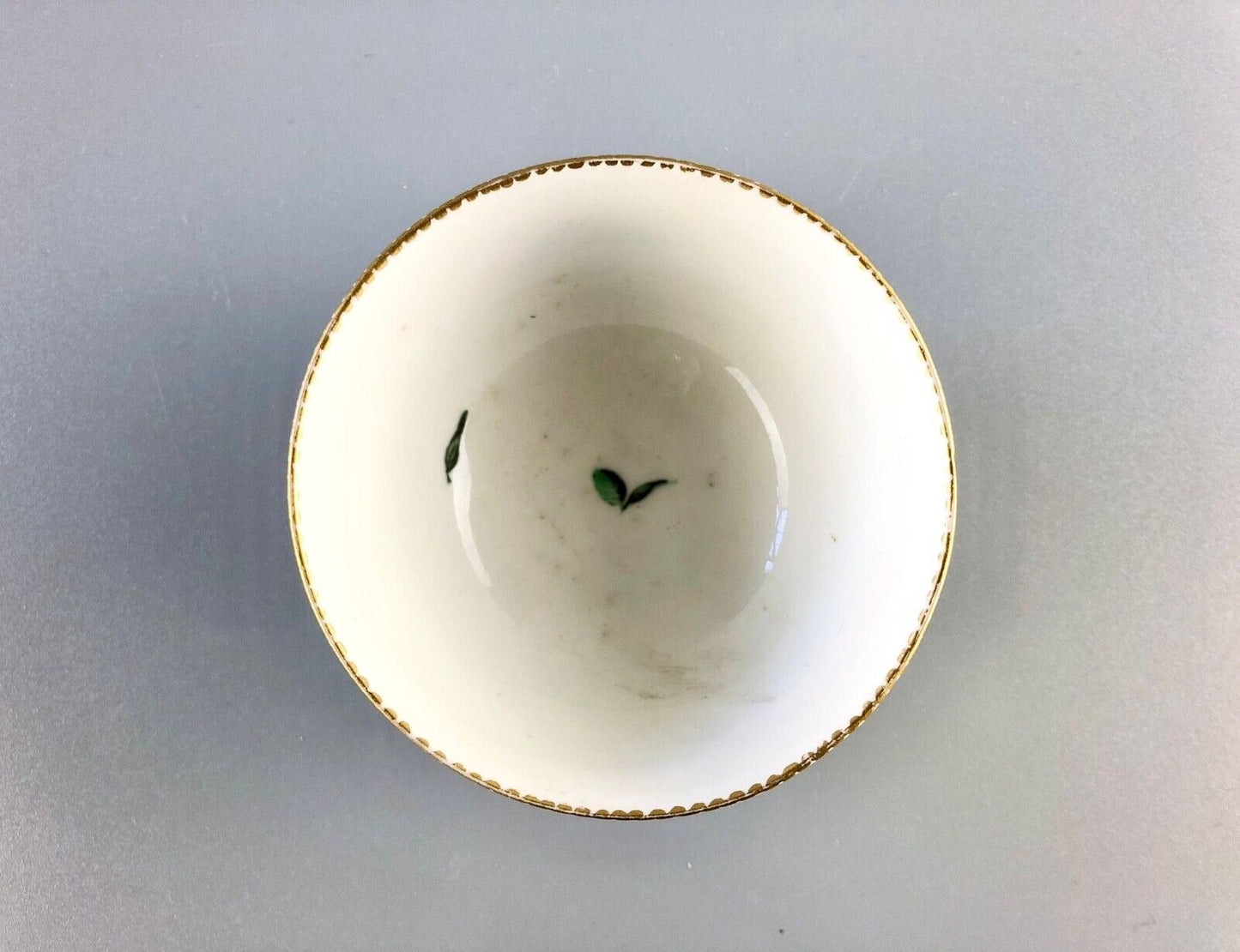 A c. 1775 Chelsea-Derby Porcelain tea bowl enamelled with foliate motifs